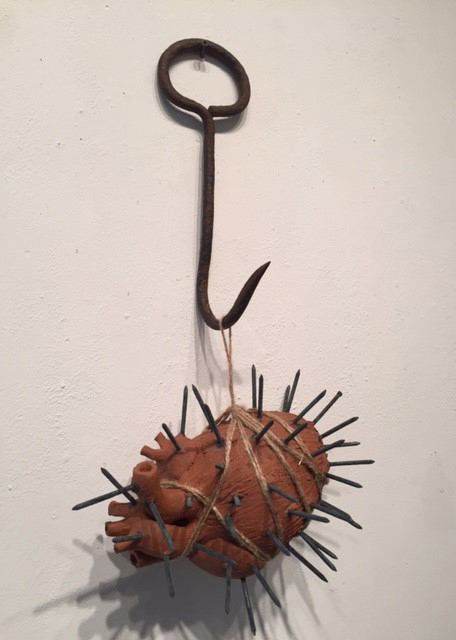 nails in a ceramic heart on a hook sculpture by Susan Mollet